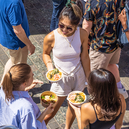 People enjoying food in the sun